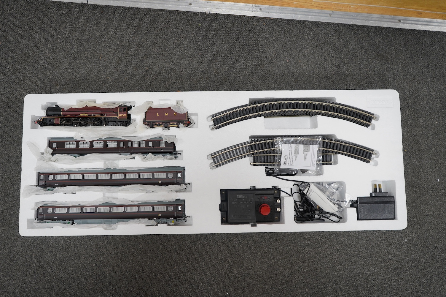 Three Hornby 00 gauge railway boxed train sets; The Royal Train (R1057), the Cornish Riviera Express (R826) and The Caledonian (R775), each comprising of a tender locomotive, three coaches, track sections, controllers, e